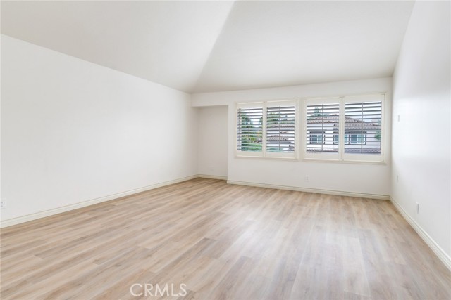 Primary Bedroom with Fresh Paint, New Flooring and Vaulted Ceiling