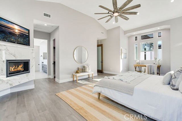 OWNER'S BEDROOM WITH FIREPLACE AND DESK AREA