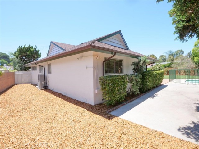 Continue the tour around the house from the concrete pation at the rear of the 4th bedroom to the huge currently unutilized huge side yard to make into whatever you want...gardening, pets, or more playspace for kids.