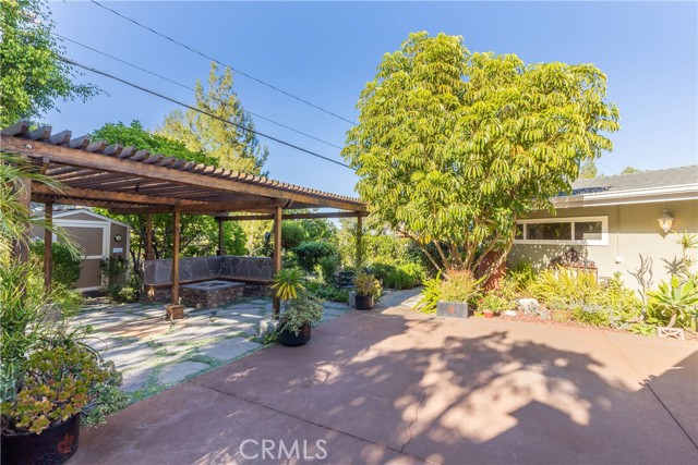 A spacious patio for outdoor dining, lounging, and relaxing with the waterfall and pond feature in the backdrop.