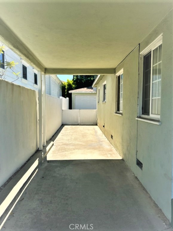 There is a Long Driveway which Leads to the Rear Yard and Garage.