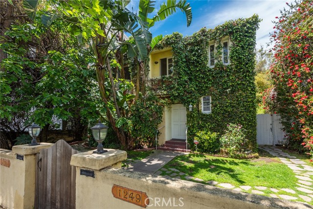 An Absolutely Incredible Opportunity to Purchase a Beautiful and Charming 1930s Historic Los Angeles Architectural Style Duplex with Preserved Original Craftsmanship in Carthay Square. Upon First Glance, You are Welcomed by the Professionally Landscaped Ivy-Covered Exterior as well as Ample Greenery and Mature Trees Surrounding the Property. The Grand Entrance is Complemented by Cove Ceilings that lead to a Rod/Iron Staircase. The Spacious Lower Unit consists of 3 bedrooms and 2 bathrooms, as well as a Private/Serene Landscape Designed Enclosed Courtyard. The Upper Unit consists of 2 bedrooms and 1 bathroom, a Gorgeous/Updated Chef's Kitchen, as well as French Doors that Open Up to a Private Deck Overlooking the Spectacular/Lush Backyard. The Archways, Cove Ceilings and Preserved Los Angeles Historic Architectural Details are Consistent Throughout the Grounds of the Property which Contribute to the Historical Charm of this Duplex. The Property has 4 Enclosed Garages, Tankless Water Heater, In-Unit W/D and a Gate at the Front/Yard/Entrance of the Property. The Lush Backyard with Abundant Greenery Provides the Utmost Privacy! Stone Pathways Lead you into the Private backyard that Provides a One of a Kind Lifestyle! This is Truly a Cannot-Miss Opportunity to Own a Duplex complete with Original Architecture Details that contribute to the Old Los Angeles Historical Charm!