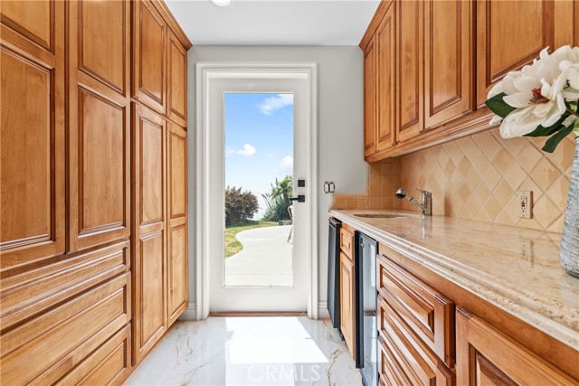 Butler's pantry with plenty storage cabinets.