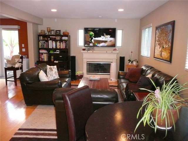 Living room with a fireplace. (photo was taken with a prior occupant's furniture)