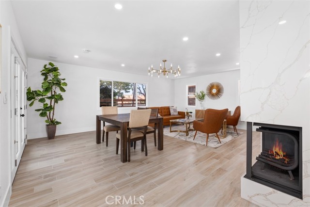 Living room features a fireplace with floor to wall quartz walls