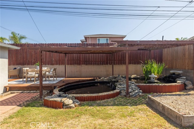 Koi pond and fountain. Enjoy outdoor dining on your finished deck.