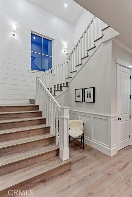 Main stairway includes floor-to-ceiling shiplap detailing