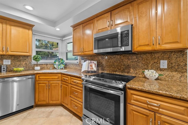 Beautiful kitchen has quality blt-ins, stone counters and lots of cabinetry.