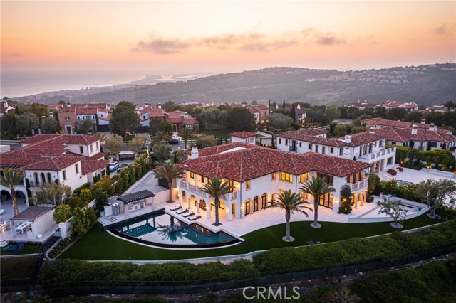 Serene, sophisticated, and enviably set in the prestigious and guard gated community of Crystal Cove, this newer custom-build sits proudly perched on a coveted hilltop lot, commanding sweeping ocean and mountain views. Inside, impeccable craftsmanship and high-end finishes blend with state-of-the-art technology to offer luxurious modern living. With six bedrooms, eight baths, and multiple entertainment areas across its generous layout, you can comfortably host large-scale gatherings without compromising privacy. From the elegant grand foyer, graceful archways usher you into the open living room and dining area, surrounded by French doors and glass sliders that inspire idyllic indoor/outdoor living. Top-of-the-line stainless steel appliances, designer cabinetry, and an oversize waterfall island define the exceptional chef’s kitchen. Steps away, the family room has a gorgeous linear fireplace and a convenient wet bar. Escape to your own slice of paradise in the lush backyard where you can take a rejuvenating dip in the pool and spa surrounded by breathtaking panoramas. Host alfresco celebrations around the pergola’s Hibachi grill, pizza oven, and fire pit. Additionally, this incredible haven is available for short-term lease.