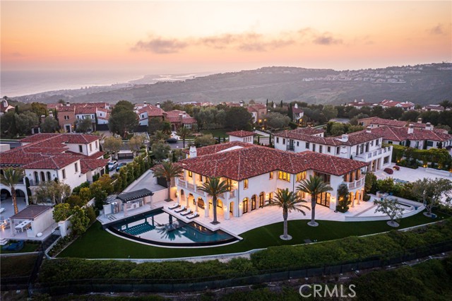 Serene, sophisticated, and enviably set in the prestigious and guard gated community of Crystal Cove, this newer custom-build sits proudly perched on a coveted hilltop lot, commanding sweeping ocean and mountain views. Inside, impeccable craftsmanship and high-end finishes blend with state-of-the-art technology to offer luxurious modern living. With six bedrooms, eight baths, and multiple entertainment areas across its generous layout, you can comfortably host large-scale gatherings without compromising privacy. From the elegant grand foyer, graceful archways usher you into the open living room and dining area, surrounded by French doors and glass sliders that inspire idyllic indoor/outdoor living. Top-of-the-line stainless steel appliances, designer cabinetry, and an oversize waterfall island define the exceptional chef’s kitchen. Steps away, the family room has a gorgeous linear fireplace and a convenient wet bar. Escape to your own slice of paradise in the lush backyard where you can take a rejuvenating dip in the pool and spa surrounded by breathtaking panoramas. Host alfresco celebrations around the pergola’s Hibachi grill, pizza oven, and fire pit. Additionally, this incredible haven is available for short-term lease.