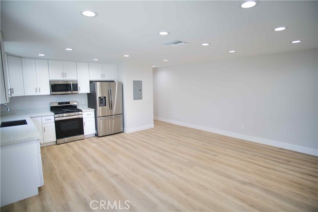 Spacious living room with all new wood flooring.