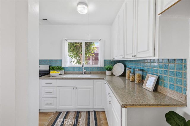 Kitchen with upgraded cabinets and window to backyard.