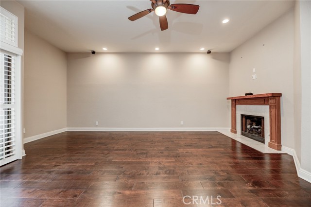 Living room with beautiful brick-rimmed fireplace