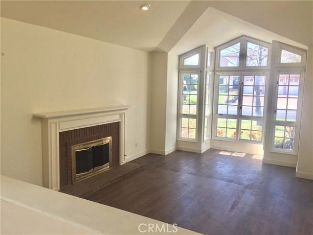Living room with vaulted ceiling and wall of windows Living room with vaulted ceiling and wall of windows