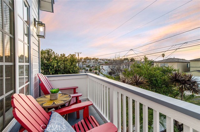 The front balcony adirondack chairs for a salt-air getaway any time of day.