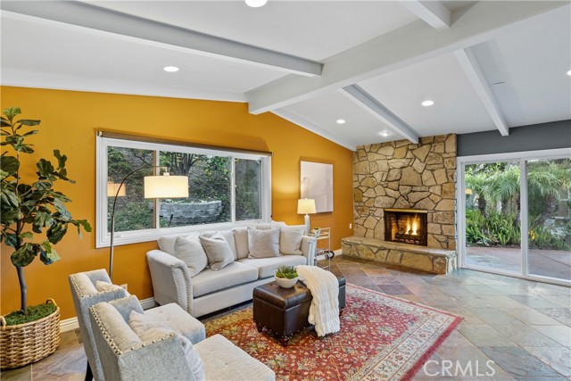 The great room opens to the inviting and lush landscape of the resort-like backyard.