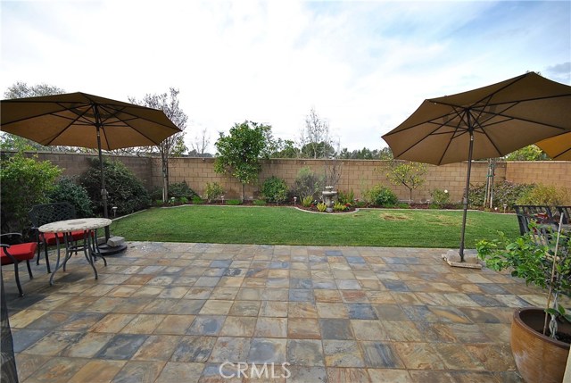 Custom Tile Patio & Water Fountain in Backyard