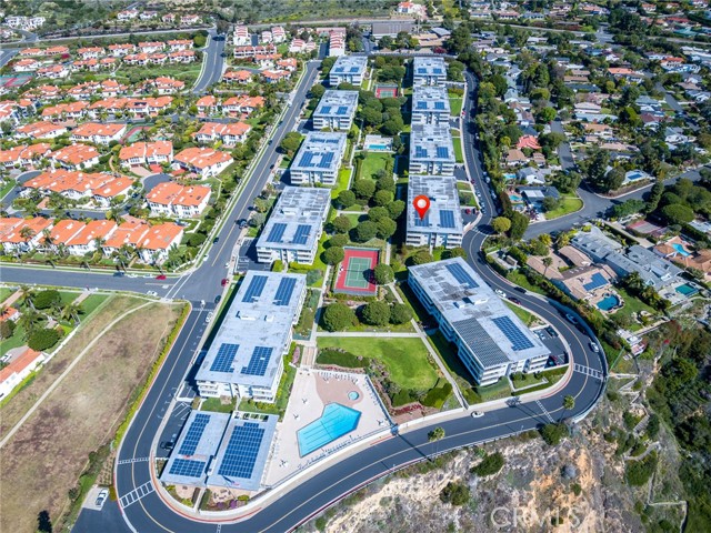 Aerial view showing the entire complex. Visible are all 10 buildings, HOA clubhouse/gym building, two pools and two tennis courts.