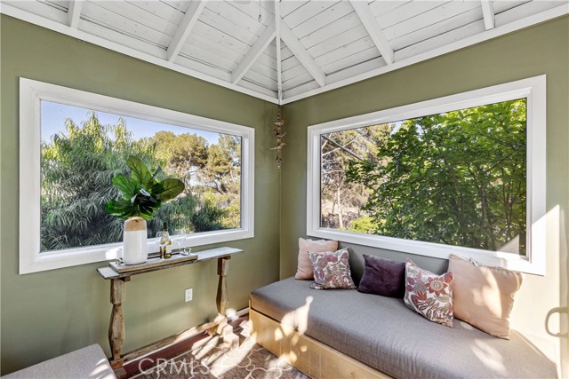 Nestled in the backyard is an intimate and versatile screened-in patio to enjoy the outdoor clime in comfort.