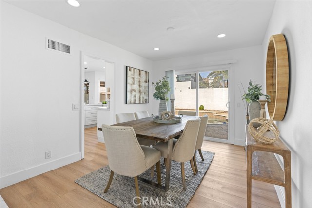 Dining area just off the kitchen, with recessed lighting, and a direct slider to the pool area.