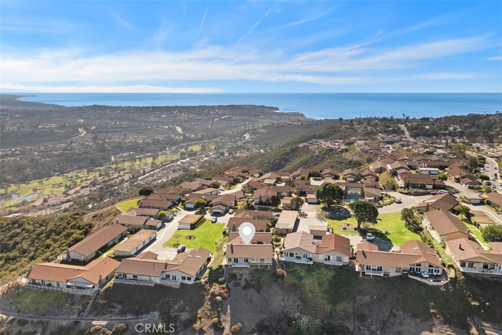 Truly a one-of-a-kind residence that must be seen to fully appreciate the panoramic views, timeless elegance, and impeccable attention to detail. This single-level gem in one of Laguna Niguel’s most desirable neighborhoods has been exquisitely remodeled to combine modern luxury with sophisticated design. Every detail of this home has been meticulously curated, with thoughtful updates and high-end finishes that you’ll notice the moment you walk through the door. At the heart of the home is a stunning chef’s kitchen designed for both cooking and entertaining. An oversized Quartz Island takes center stage, surrounded by top-of-the-line appliances, including a Wolf 6-burner range, a Sub-Zero refrigerator, a Bosch dishwasher, and sleek custom cabinetry with abundant storage. The adjacent dining area, anchored by a sophisticated double-sided fireplace, flows effortlessly into a light-filled living room with vaulted ceilings and oversized windows. These expansive windows frame the living spaces and, along with the adjacent patio, create an effortless indoor-outdoor flow—perfect for enjoying sunsets and stunning views of Saddleback Mountain and the twinkling city lights.The primary suite is a serene retreat, featuring a spa-like bath with luxurious marble finishes, an elegant soaking tub, and an oversized shower. The generously sized secondary bedroom offers comfort and style, while the versatile bonus room—accessible from both the interior and exterior—serves as an ideal office, guest room, or creative space, complete with custom built-ins and ample privacy. This exceptional home offers resort-style amenities, including a pool, relaxing spa, clubhouse, and lush greenbelts. Its prime location places you just minutes from Southern California’s finest beaches, luxury resorts like the Waldorf Astoria and Ritz-Carlton, and world-class dining and shopping at Monarch Beach and Fashion Island. With easy access to hiking trails, golf courses, and some of the region’s most desirable recreation, this home is move-in ready and truly an extraordinary opportunity to experience impeccable updates and meticulous attention to detail. Discover California living at its finest!