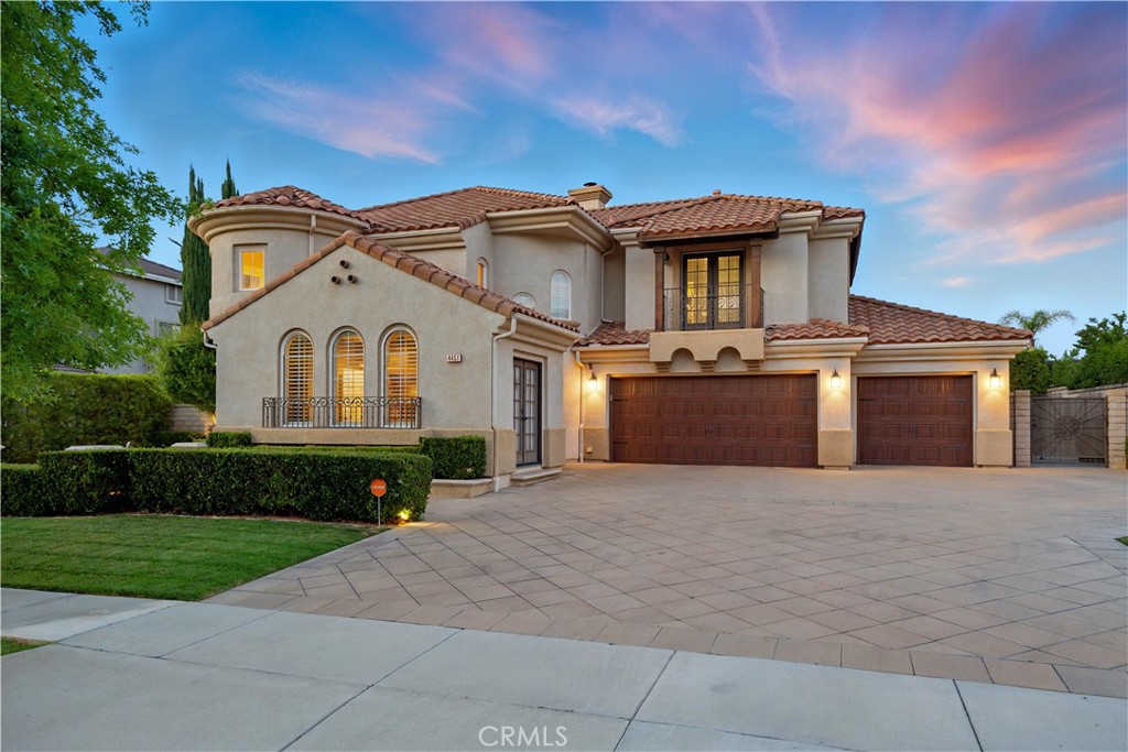 Welcome to a home that offers an exceptional lifestyle. Birdie Drive is a premier street in Eagle Glen and this home is on the view side. This Mediterranean home has wonderful curb appeal with a paver driveway (parks 6+), custom iron work, fountain and landscaping. The backyard includes a beautiful pool and spa with waterfalls and gas fire bowls. There is also a built in BBQ area with room for a large table for al fresco dining under the olive trees. An amazing huge covered patio with a wood burning and gas fireplace and an outdoor television that is perfect for entertaining or casual days spent with family and friends. Another stand out feature is the upstairs Home Theater. Imagine having the perfect spot to host sporting events or watch movies. The Home Theater includes comfortable seating for 5 (room for much more), surround sound, projector, screen, all equipment, black out blinds and noise insulated walls. The home continues the Mediterranean theme throughout with soaring ceilings, a beautiful entry with rotunda, a rounded staircase and Juliet balcony with iron railings. The kitchen has stainless appliances, granite counters and a large breakfast area. The downstairs also includes a large open living and dining room, a flex space that can be used for office or gym, a family room with a fireplace and a full bedroom suite. Upstairs you will find the main suite with an exceptional view, 2 additional bedrooms, a shared bathroom, the home theater and an open office space. The air conditioning, furnace, water heater and whole house fan have been replaced. 3 car garage with two newer remote garage doors and direct access.This home is only a few blocks from the Eagle Glen Golf Course, which will soon also offer Pickleball, Woodrow Wilson Elementary School and two parks. This is a very walkable and friendly neighborhood. Taxes and Mello Roos are lower than newer neighborhoods and the mature greenery makes this a beautiful place to live.