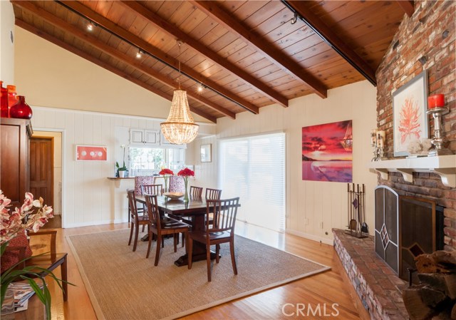 Vaulted ceilings, wood floors and paneling in dining room