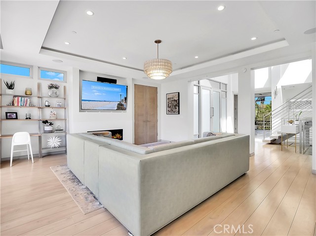 Living room with fireplace overlooking the large backyard.