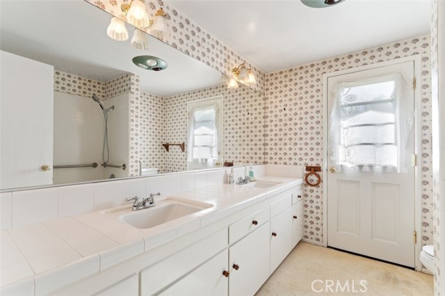 Full bath with a door to the exterior.