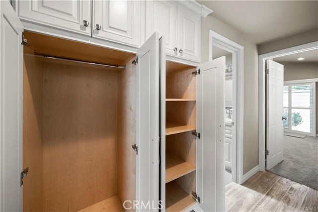 The thoughtfully designed hall closet offers hanging space for coats and other items on the left side and plenty of shelves on the right side and up top for linens and foldables.
