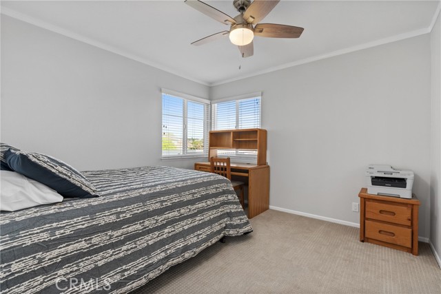 One of the secondary bedrooms with a ceiling fan and mirrored closet doors!