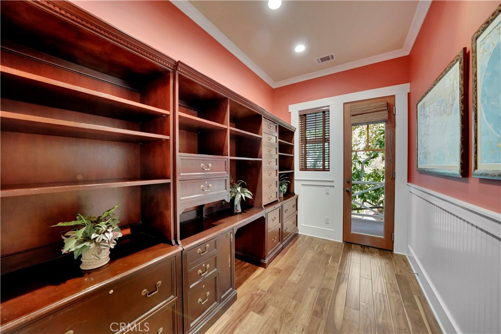 office with built in cabinetry and private patio