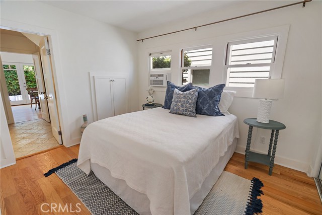 Another bedroom with two walls of storage and an attached bathroom.