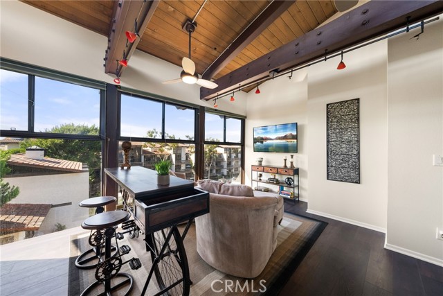 Love and a view and privacy? You will love this family room with a wall of picture windows.