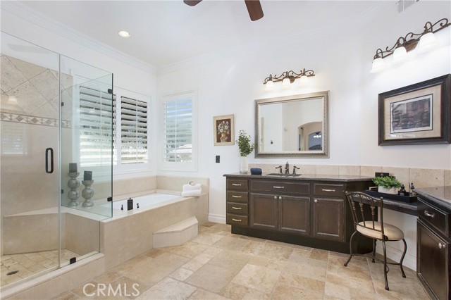 Spa like bath with walk in shower, dual vanities and soaking tub with marble surround