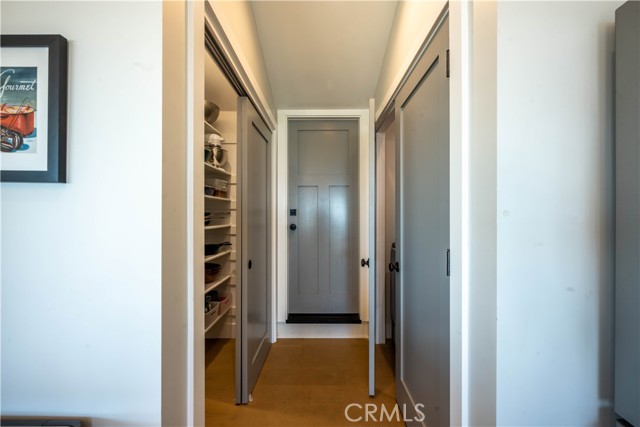 Hallway to pantry and washer dryer closet and garage on main level