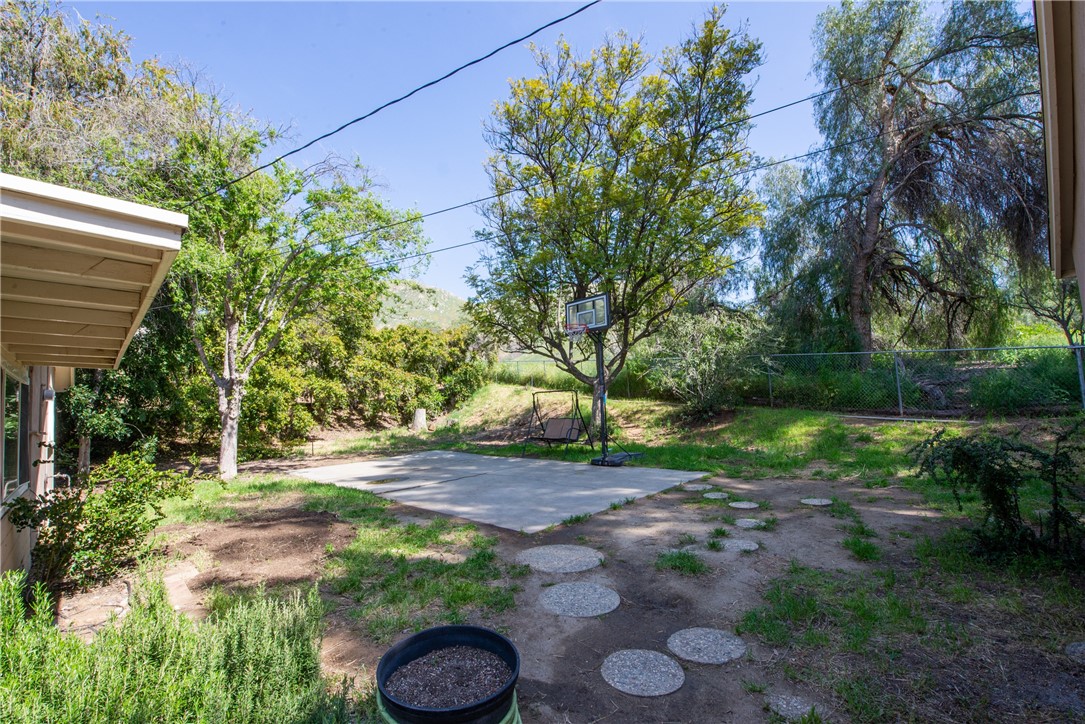 The private backyard has a retreat feel with no home behind it and plenty of trees and greenery that provides a lot of privacy.