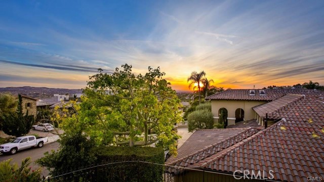 Located in the prestigious community of Hidden Hills Estates, this modern yet luxurious home at the end of a cul-de-sac is available just in time for summer! At the top of the hill, you'll arrive at a set of double doors with leaded glass. Once inside, the welcoming foyer provides a view into the rear of the home, impressive staircase mezzanine and into the spacious living room. Anchored by a beautiful carved fireplace mantle, the living room has voluminous ceilings and a cozy bay window with storage. An elegant dining room with wainscoting detail has French doors out to the private patio. Entering into the kitchen you are greeted by an oversized island with seating and ample counter space. Furthermore, there is a large window, stainless steel appliances including a brand new built in refrigerator, solid surface counters throughout and a modern subway tile backsplash. The kitchen flows into the large breakfast nook and family room with fireplace and wet bar.  The 16,000 square-foot lot looks like a resort with a saltwater pool, spa, fruit trees and sport court for all of your outdoor activities.  Upstairs is the double door entry into the elegant master bedroom suite again featuring voluminous ceilings, fireplace, private balcony with sunset views and walk in closet with custom organizers. A spa like master bath has dual vanities, free standing bathtub, shower and private toilet room. Located opposite the master bedroom are two ample size secondary bedrooms connected by a Jack and Jill bathroom.  Downstairs are two more bedrooms and 1 1/2 baths. One of them is an ideal guestroom or In-law suite with direct access to the outside. The other makes an excellent office, gym or bonus room since it is tucked away from the rest of the home and also provides easy access to the outside without even accessing the main house. Other amenities include shutters, ceiling fans, hardwood floors, new carpet and paint throughout, recessed lighting throughout, built in bookshelves, built in window seats with storage, modern chandeliers and fixtures, central vacuum system, two air-conditioning units, a three car garage with 220V for an electric car and one garage even has a drive-through door into the backyard, a gated driveway,  and oh so many more upgrades to list.