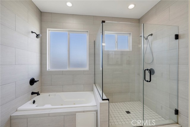 Two shower heads in primary en suite bathroom. .