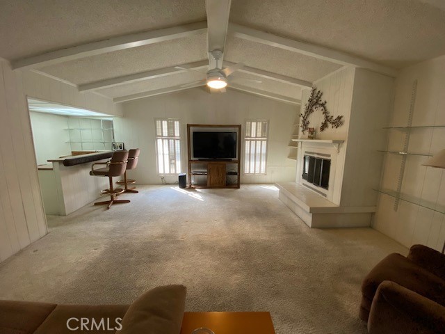 Family Room with beamed ceiling, Fireplace, and Bar/office area.
