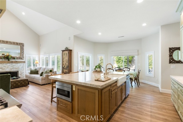 This homeowner tastefully mixed the stainless style appliances with some gold touches for such a unique look. The island has a ton of cupboard space, microwave drawer and large farm style sink.
