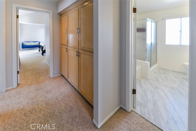 View of the upstairs hallway with more storage cupboards.