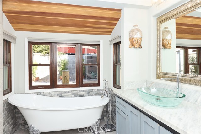 soaking tub embraced by
lush landscape and tranquil water feature sound.