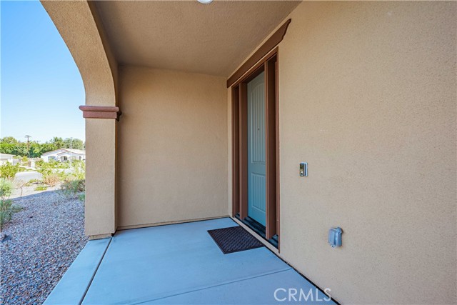 Front door is massive with ring doorbell, and concreted front porch area.