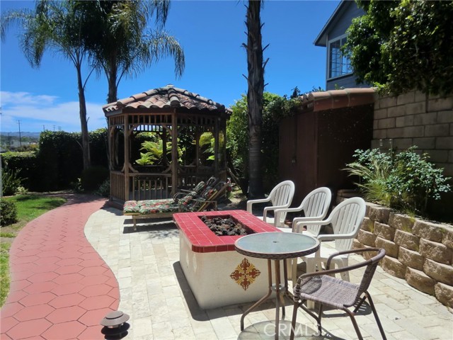 Back Yard with Gazebo, Electric start Fire Table & Elec. start Natural Gas Grill