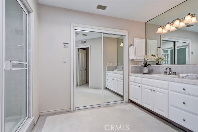 Master suite bath with 2 separate walk in closets with built in organizers