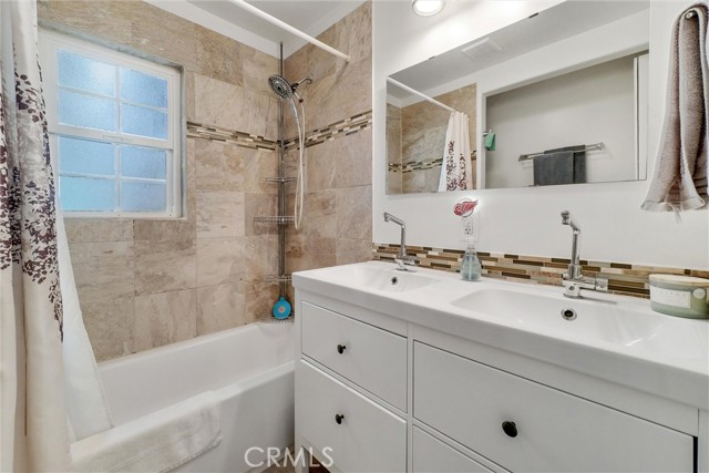 Upgraded Bathroom. Dual Vanity sinks, tiled bathtub/shower combo