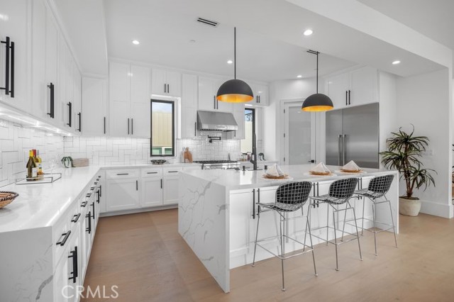 Chef's Kiss - walk-in pantry, premier appliances, expansive center island, waterfall quartz countertops