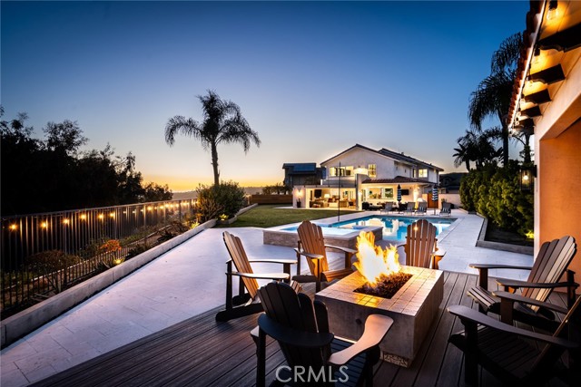 Experience the epitome of luxurious coastal living with this exceptional San Clemente property that seamlessly blends stunning canyon and ocean views with unparalleled amenities. Nestled in the coveted Montego neighborhood of Rancho San Clemente, and expanded/renovated in 2018, this one-of-a-kind home offers over 3200 sqft of meticulously designed living space on an expansive 13,000+ sqft lot situated at the end of a tranquil cul-de-sac. Spacious living room welcomes you with a beautiful fireplace and cathedral plank ceilings. Gourmet kitchen features an oversized island with cabinets on both sides for plenty of storage, a handy prep sink and disposal, microwave drawer, Wolf 6 burner stove, oversized refrigerator, a Scotsman pebble ice machine, and walk-in pantry with shelves and cabinet storage. Kitchen opens to the great room and dining area, complemented by La Cantina sliding window panels that open to the backyard oasis. Outside, discover a private resort-like setting complete with a custom saltwater pool with baja shelf, spa, grass yard, limestone patio, three gas hook ups, and heated cabana with firepit and TV, perfect for relaxing or hosting family and friends. It is truly like having your very own private resort in the backyard! Upstairs features the primary suite with cathedral ceiling, walk-in closets and a wraparound balcony with panoramic canyon and ocean views. Unwind in the elegantly appointed primary bath with custom shower, soaking tub, and dual sinks. Two additional upstairs bedrooms and a loft/office/game room at the top of the stairs. Additional highlights include a downstairs converted 4th bedroom offering versatility and French door entry, 3/4 bath with walk-in shower and access to the side/backyard, 1/4 
 bath with storage, laundry room with full size stackable washer/dryer,  and luxury vinyl flooring throughout. Home also features newer tile roof, Pex plumbing, surround sound system inside and out, and fully paid for solar panels with LG battery. Systems include dual HVAC with multi-zone Nest system, Tesla charger, tankless water heater and ADT security system with remote access. Ample street parking and easy access to nearby amenities including hiking trails, beaches, shopping, restaurants, fitness center, Rancho San Clemente Tennis Club and area schools. This extraordinary property offers the ultimate Southern California lifestyle. Don't miss your chance to own this rare gem where luxury meets coastal charm in San Clemente.