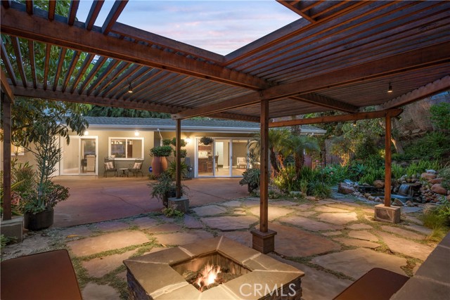 Be ready for the warm days and cool nights of the Palos Verdes Peninsula in an ambiance of paradise under the pergola covered conversation seating around the natural-gas fire pit.
